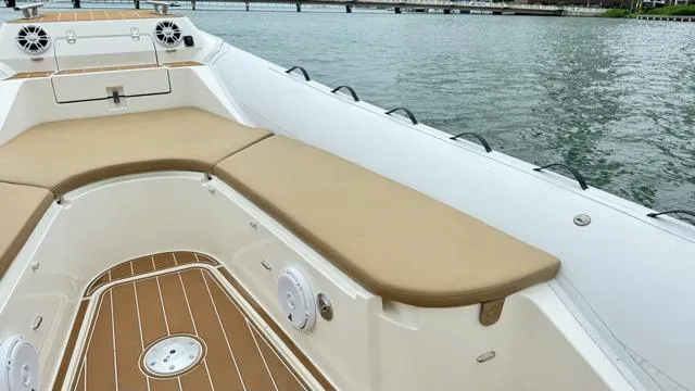 Slide: The Image of 2017 Nuova Jolly Princess boat with tan seating and wood deck on calm water. - 11