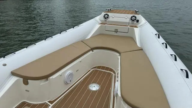 Slide: The Image of 2017 Nuova Jolly Princess boat with tan seating and wood accents on calm water. - 16