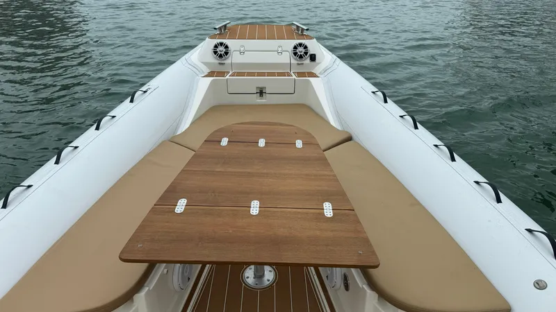 Slide: The Image of 2017 Nuova Jolly Princess boat with wooden deck and beige seating on water. - 18