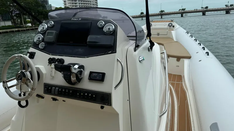 Slide: The Image of 2017 Nuova Jolly Princess boat with modern dashboard, steering wheel, and waterfront view. - 25