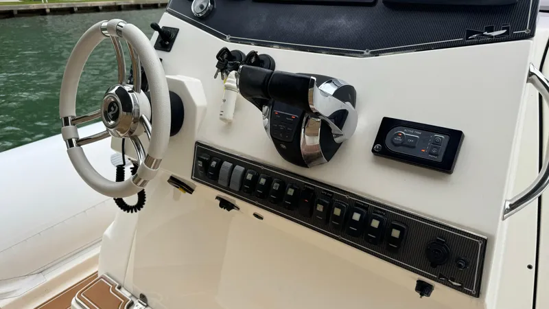 Slide: The Image of Control panel of a 2017 Nuova Jolly Princess boat with steering wheel and switches. - 26