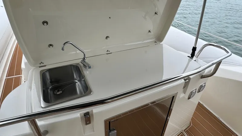 Slide: The Image of 2017 Nuova Jolly Princess yacht kitchenette with sink and storage, overlooking the water. - 35