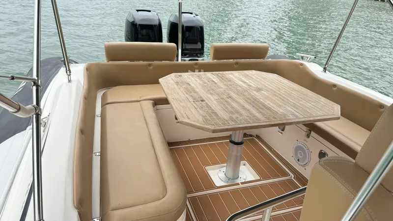 Slide: The Image of 2017 Nuova Jolly Princess boat interior with beige seating and wooden table. - 42