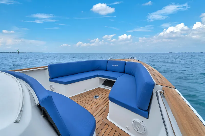 Slide: The Image of Luxurious 2019 Fjord 38 boat with blue seating, wooden deck, and ocean view. - 11