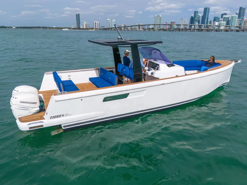 Slide: The Image of 2019 Fjord 38 boat on water with city skyline in background. - 38
