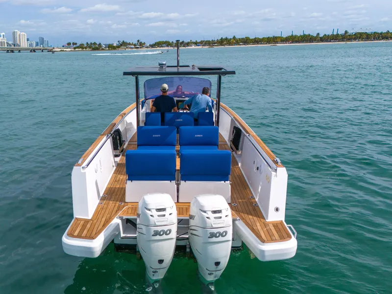 Slide: The Image of Fjord 38 boat, 2019 model, cruising on clear blue water with twin 300 horsepower engines. - 39