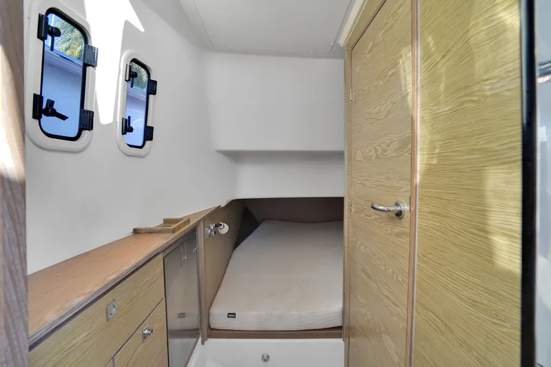 Slide: The Image of Cabin interior of 2019 Fjord 38 boat with bed and wooden cabinetry. - 7