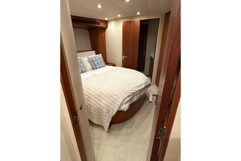 Slide: The Image of Cozy bedroom interior on 1999 Merritt Sportfish yacht with elegant wood finishes. - 10