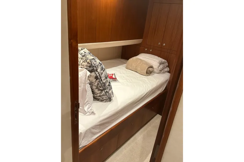 Slide: The Image of Cozy cabin interior of 1999 Merritt Sportfish with wooden accents and plush bedding. - 14