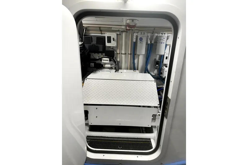 Slide: The Image of Engine room of a 1999 Merritt Sportfish boat, featuring mechanical equipment and filters. - 16