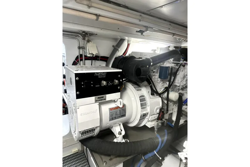 Slide: The Image of Engine room of 1999 Merritt Sportfish boat with Stamford generator and wiring. - 18