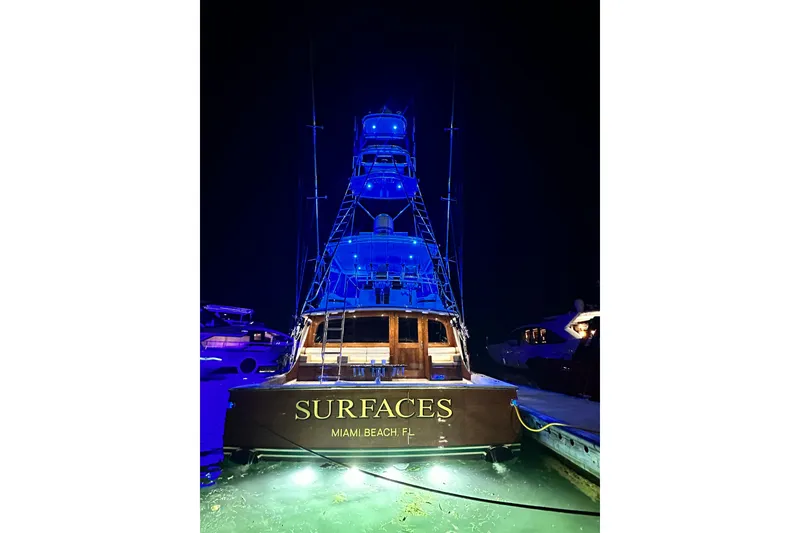 Slide: The Image of 1999 Merritt Sportfish yacht "Surfaces" illuminated in blue at night, Miami Beach. - 24
