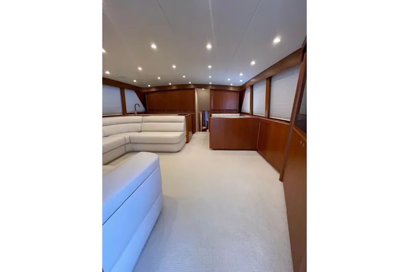 Slide: The Image of Luxurious interior of a 1999 Merritt Sportfish yacht with elegant wood finishes and plush seating. - 4