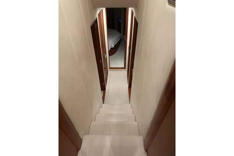 Slide: The Image of Stairway inside 1999 Merritt Sportfish yacht, leading to a cozy bedroom. - 5