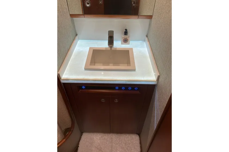 Slide: The Image of Luxurious bathroom vanity on 1999 Merritt Sportfish yacht, featuring modern sink and ambient lighting. - 6