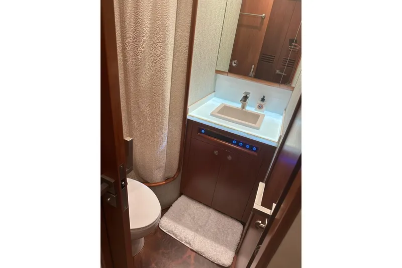 Slide: The Image of Bathroom interior of a 1999 Merritt Sportfish yacht, featuring a sink and toilet. - 7