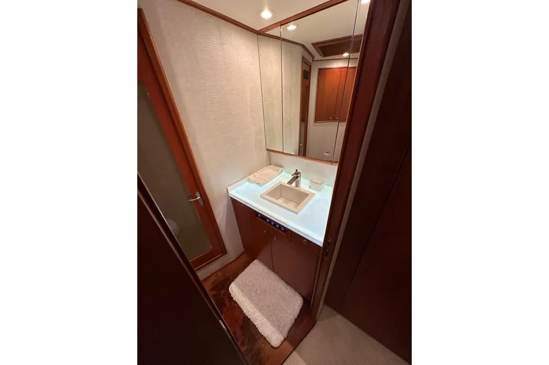 Slide: The Image of Luxurious bathroom in 1999 Merritt Sportfish yacht with modern sink and elegant wood finishes. - 8