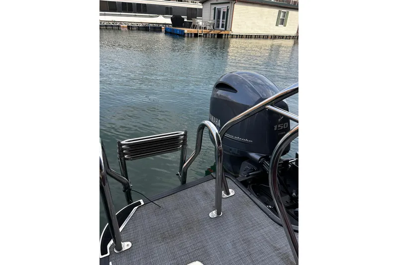 Slide: The Image of 2023 Starcraft EXS 3 boat with Yamaha 150 outboard motor at a dock. - 6