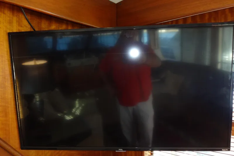 Slide: The Image of Flat-screen TV on 1977 Hatteras 53 Motor Yacht interior, reflecting surroundings. - 111