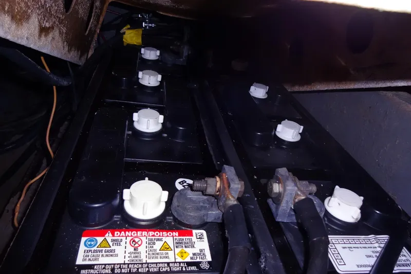 Slide: The Image of Battery compartment of a 1977 Hatteras 53 Motor Yacht with safety labels visible. - 119