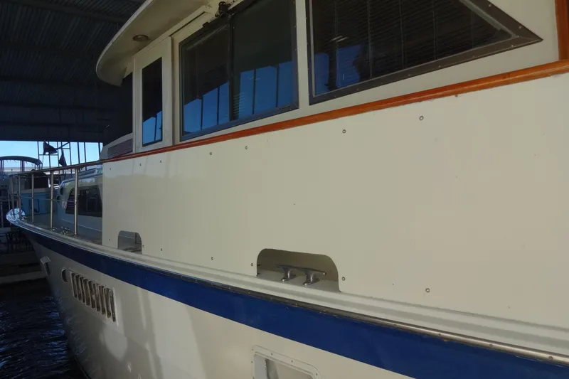 Slide: The Image of 1977 Hatteras 53 Motor Yacht docked under a covered marina. - 12