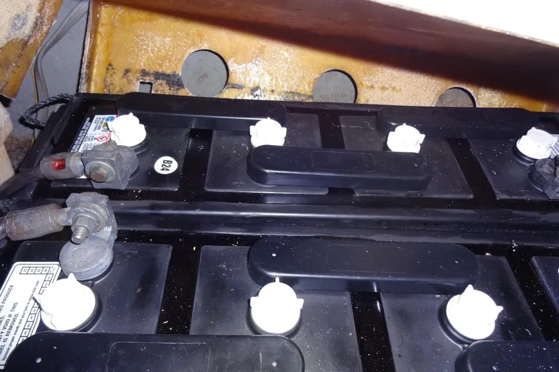 Slide: The Image of Battery compartment of a 1977 Hatteras 53 Motor Yacht, showing connections and terminals. - 121