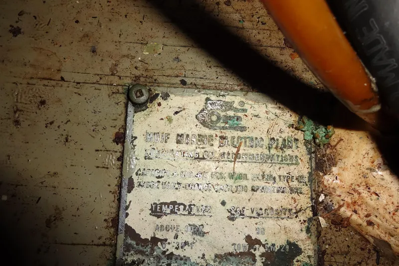 Slide: The Image of Close-up of a weathered metal plate on a 1977 Hatteras 53 Motor Yacht. - 125