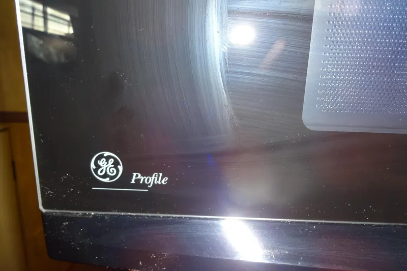Slide: The Image of Close-up of a GE Profile appliance with reflective surface. - 127