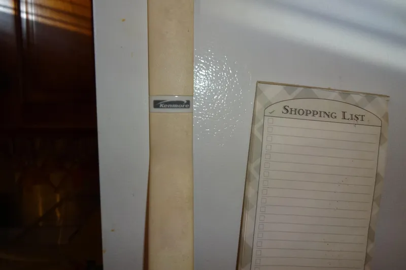 Slide: The Image of Kenmore refrigerator with a blank shopping list pad attached. - 128