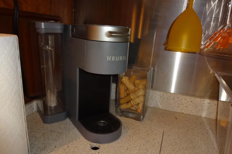 Slide: The Image of Keurig coffee maker on Hatteras 53 Motor Yacht, 1977 model, with corks and kitchen items. - 131