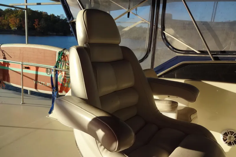 Slide: The Image of Captain's chair on 1977 Hatteras 53 Motor Yacht, with scenic water view. - 133