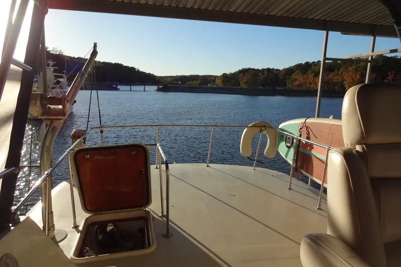 Slide: The Image of 1977 Hatteras 53 Motor Yacht deck overlooking serene lake and autumn foliage. - 138