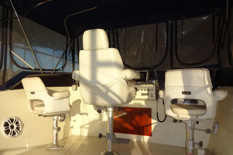 Slide: The Image of Interior helm of 1977 Hatteras 53 Motor Yacht with white captain chairs. - 144