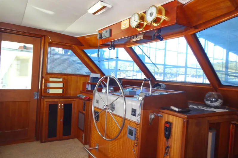 Slide: The Image of Interior helm of 1977 Hatteras 53 Motor Yacht with wooden finish and navigation instruments. - 16