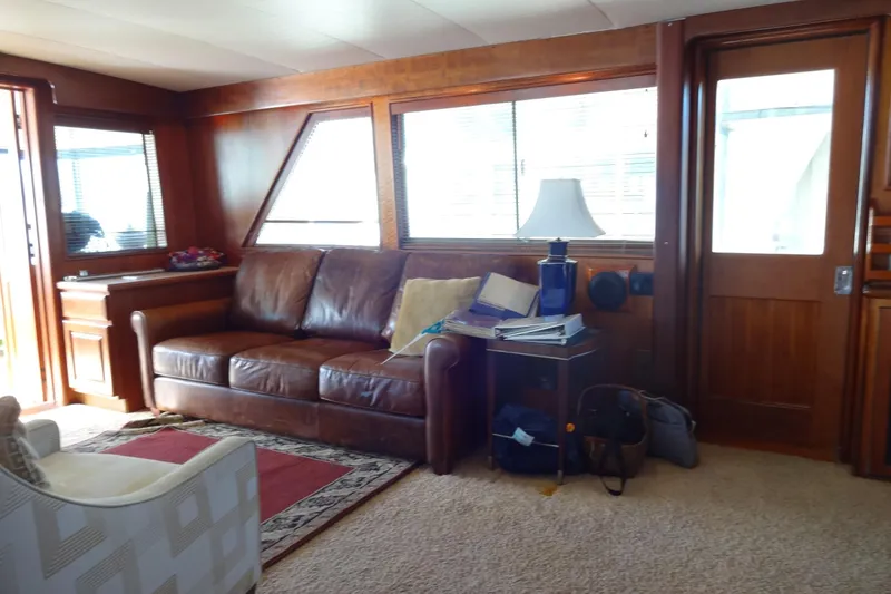 Slide: The Image of Interior of 1977 Hatteras 53 Motor Yacht with leather sofa and wooden accents. - 19