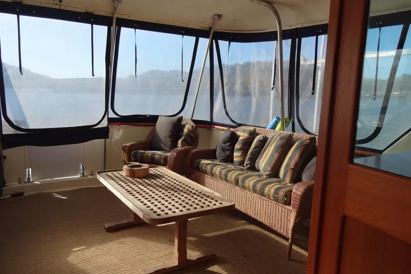 Slide: The Image of 1977 Hatteras 53 Motor Yacht interior with wicker seating and panoramic windows. - 22