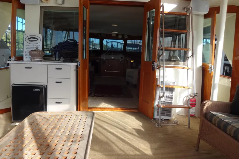 Slide: The Image of Interior view of a 1977 Hatteras 53 Motor Yacht with wooden accents and nautical decor. - 24
