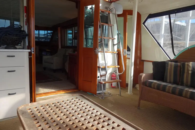 Slide: The Image of 1977 Hatteras 53 Motor Yacht interior with seating, ladder, and wooden accents. - 26