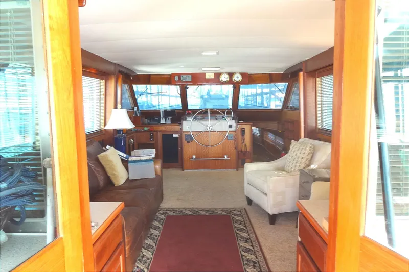 Slide: The Image of Interior of 1977 Hatteras 53 Motor Yacht with wooden accents and comfortable seating. - 27