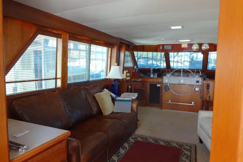 Slide: The Image of Interior of 1977 Hatteras 53 Motor Yacht with leather sofa and helm station. - 28