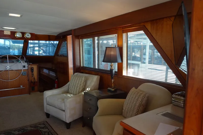 Slide: The Image of Interior of 1977 Hatteras 53 Motor Yacht with cozy seating and nautical decor. - 29