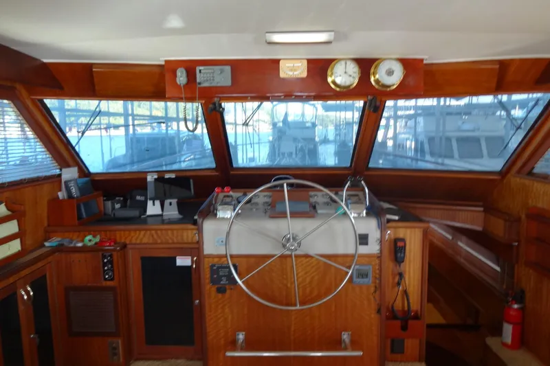 Slide: The Image of Interior helm of 1977 Hatteras 53 Motor Yacht with wooden finish and steering wheel. - 35