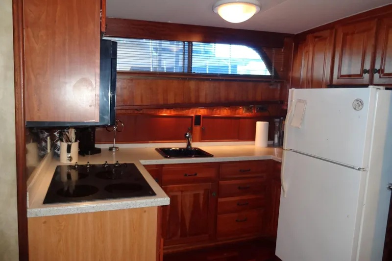 Slide: The Image of 1977 Hatteras 53 Motor Yacht kitchen with wooden cabinets and modern appliances. - 36