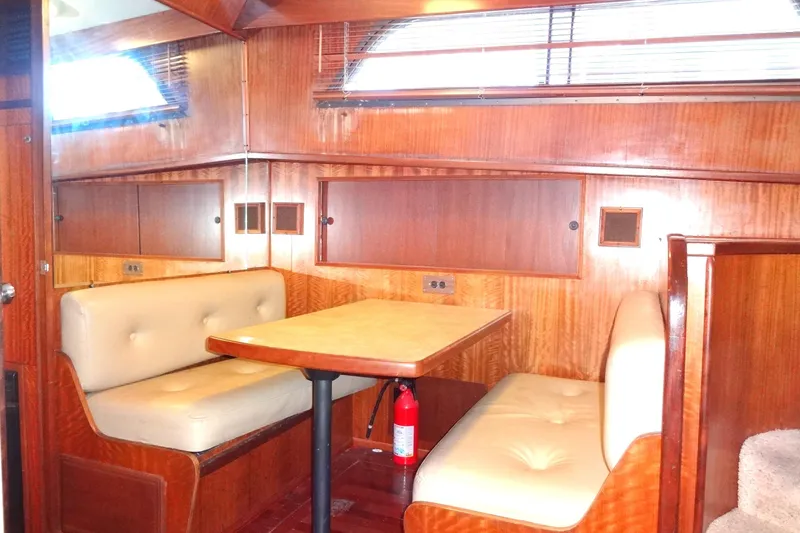 Slide: The Image of Interior of 1977 Hatteras 53 Motor Yacht with wood paneling and cushioned seating. - 37