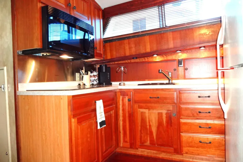 Slide: The Image of 1977 Hatteras 53 Motor Yacht kitchen with wooden cabinets and modern appliances. - 38