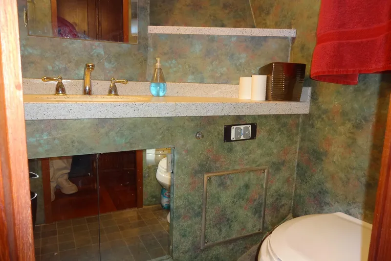Slide: The Image of 1977 Hatteras 53 Motor Yacht bathroom with sink, mirror, and toilet. - 40