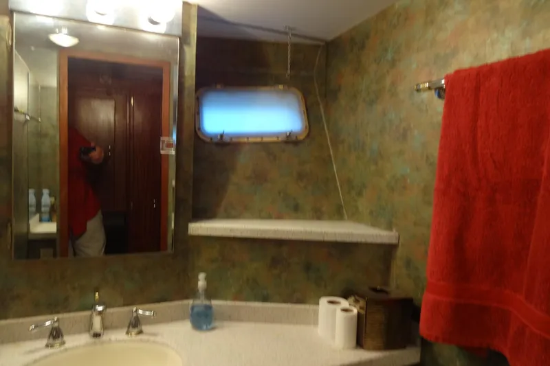 Slide: The Image of Bathroom interior of 1977 Hatteras 53 Motor Yacht with mirror, sink, and red towel. - 41