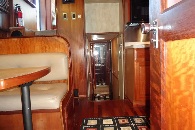 Slide: The Image of Interior of 1977 Hatteras 53 Motor Yacht with wood paneling and seating area. - 47