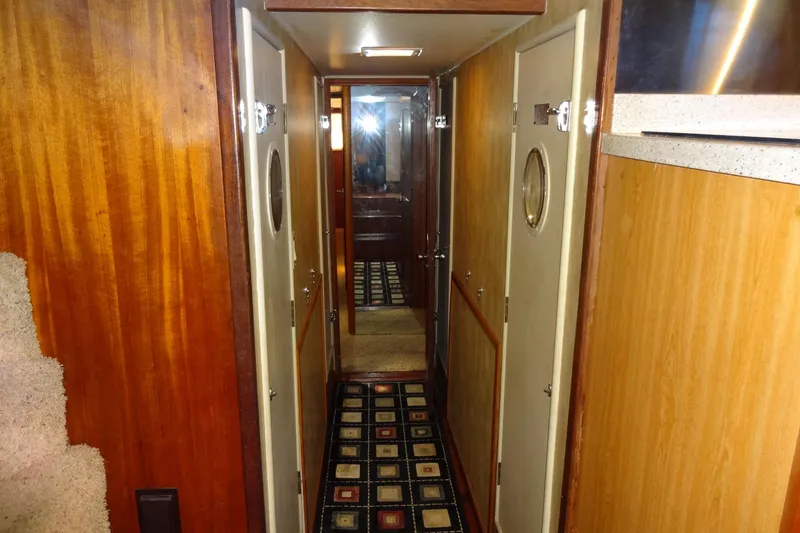 Slide: The Image of Interior hallway of 1977 Hatteras 53 Motor Yacht with wood paneling and patterned carpet. - 48