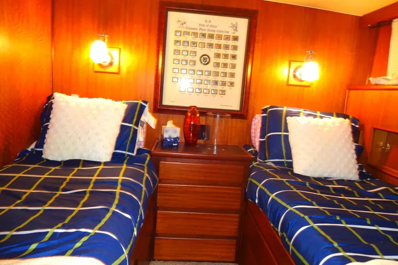 Slide: The Image of Cozy twin cabin in 1977 Hatteras 53 Motor Yacht with nautical decor and warm lighting. - 51